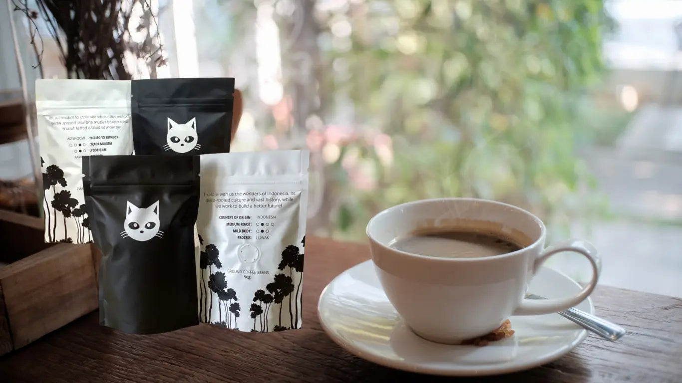 Artisan ethical coffee pouches featuring The Poop Coffee logo and cat artwork alongside perfectly brewed mug of premium kopi luwak coffee alternative, capturing the essence of luxury civet coffee without animal cruelty.